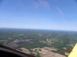 Heading home. Lake Ontario is in the distance. The plume of smoke at the edge of the lake in the center of the photo is the Nine Mile Point nuclear plant.