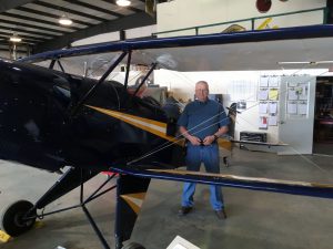 Bob Bailey, Aviation Curator, runs the Aircraft Restoration Workshop. Here he is with his own personal aircraft, a 1961 Bucker Jungmann.