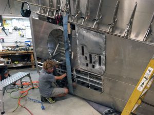 Intern working on right wing landing gear installation