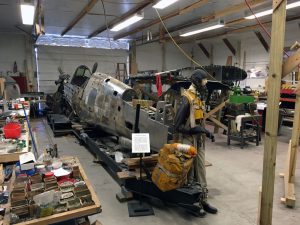 P-40 restoration shop with pilot replica